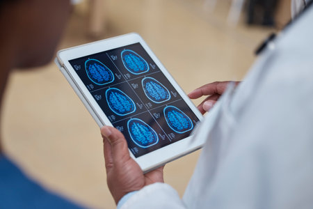 Doctor, hands and tablet with brain scan in healthcare examination, surgery or anatomy research at...
