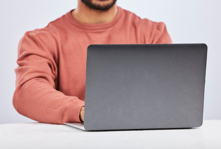 Laptop space, IT and closeup of man in studio, white background or programming digital code. Model, software developer and back of screen with computer engineer, technology and coding date on websiteの写真素材
