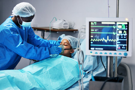 Healthcare, doctor and patient in mask for oxygen in surgery, emergency care and hospital bed. Breathing, monitor and air, surgeon helping person in operation, digital graphs to check medical resultsの写真素材