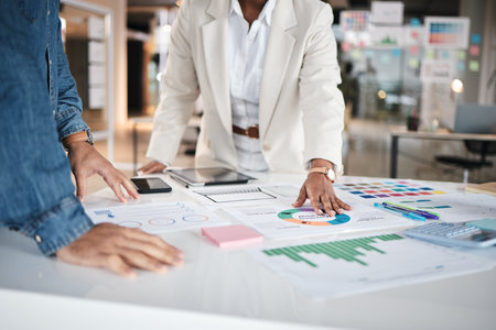 Hand, business people and financial meeting in office on data, chart and statistics for budget review. Finance, analysis and advisor team with savings, graph or brainstorming problem solving solutionの写真素材