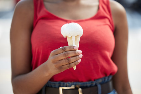 Hands, woman and vanilla ice cream for dessert, cool snack and sweet food outdoor in city street,...