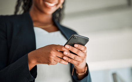 Closeup, worker or hands typing on a phone for social media content, internet post or website notification. Searching, digital news blog or woman texting on online networking mobile app in officeの写真素材