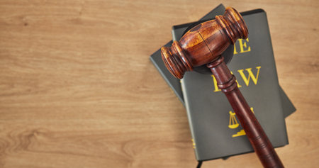 Background, law books and gavel on table at mockup space of judge, justice or lawyer in courtroom. Overhead, hammer and research knowledge of legal system, constitution and truth, litigation or trialの写真素材