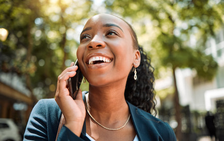 Happy, thinking and a black woman on a phone call in the city for communication, networking and chat. Smile, ideas and an African employee speaking on a mobile in town for work, planning or contactの写真素材