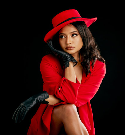 Woman, retro red fashion and glamour in studio with vintage beauty and wealth. Young female person, black background and luxury style with cosmetics, designer rich clothes and model with confidenceの写真素材