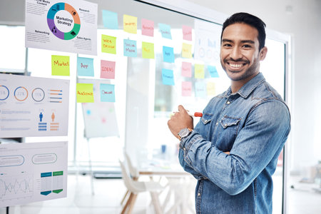 Data, graphs and man business consultant with financial information or profit strategy of startup growth or goal. Portrait, presentation and young entrepreneur planning or brainstorming a proposalの写真素材