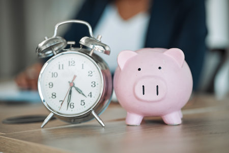 Piggy bank, clock or business person writing financial info or budget for savings or investment in office. Time management, reminder blur or professional worker with notes for insurance or taxesの写真素材