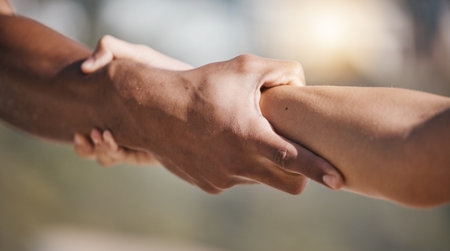 People, holding hands and pull arm for teamwork, solidarity and trust for safety, training or...