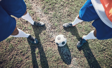 Legs, soccer and ball with a team ready for kickoff on a sports field during a competitive game from above. Football, fitness and teamwork on grass with players standing on grass to start of a matchの写真素材