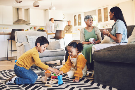 Family home, kids and siblings with toys, living room and play on floor with grandparents, parents or games. Men, women and children for building blocks, development and learning in lounge in houseの写真素材