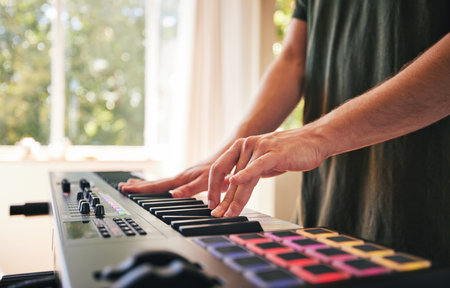 Hands, man and synthesizer piano for music, talent and skills in home studio. Closeup, musician and playing electrical keyboard for audio performance, sound artist and learning notes on instrumentの写真素材