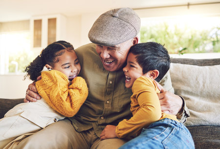 Hug, grandpa or happy kids laughing in family home on sofa with love enjoying bonding time together. Smile, affection or senior grandfather relaxing with funny children siblings on couch in houseの写真素材