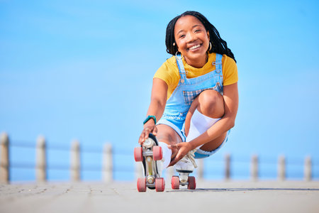 Portrait, roller skating and balance with a black woman by the sea, on the promenade for training or...