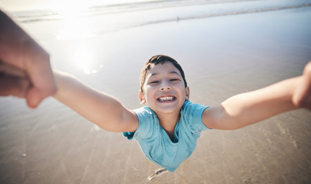 Person, spin kid and pov at beach, portrait and smile for game, excited and playing by water in...