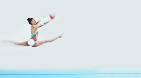 Gymnastics, jump and woman with ball in performance to exercise, train and mockup space. Sports, moving and dancing gymnast, athlete or person in competition for creative talent, energy and fast blurの写真素材