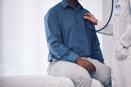 Doctor, patient and consultation with stethoscope for heart, healthcare services and medical mockup space. Closeup, cardiology and check lungs for breathing, chest assessment and hospital consultingの写真素材
