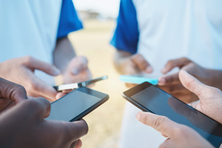 Hands, phone and networking with sports people in a huddle for communication or connectivity....