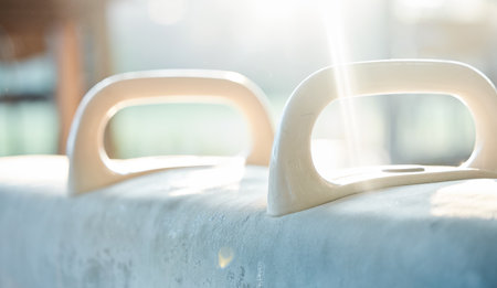 Closeup of gymnastics horse in gym for fitness, exercise equipment and training with grip. Background, handle and sports beam for strength, balance and workout in gymnast studio, club and performanceの写真素材