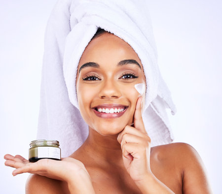 Beauty shine, portrait or happy woman with cream container for skincare, facial hydration or spa product results. Bathroom cosmetics, face moisturizer or morning treatment person on purple backgroundの写真素材