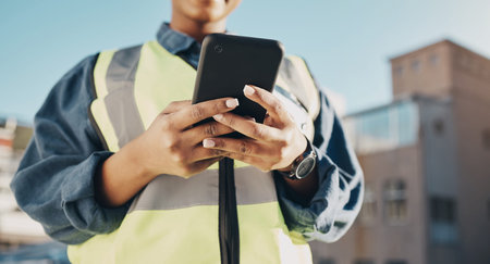 Phone, construction worker hands and person typing, networking or search info about inspection,...