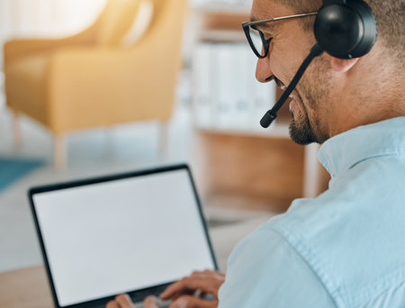 Call center, man and mockup on laptop, screen and customer service consulting, communication or support from the back. Salesman, agent or computer space for telemarketing, web advisory or CRM contactの写真素材