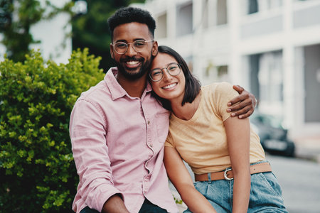 Weve got each others backs no matter what. Cropped portrait of two young businesspeople sitting close together while outside during the day.の写真素材