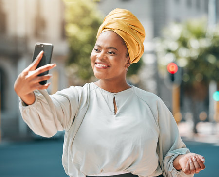 City, business and black woman with a smile, selfie and confident with happiness, memory and profile picture. Female person, professional or happy entrepreneur with joy, outdoor and social media postの写真素材