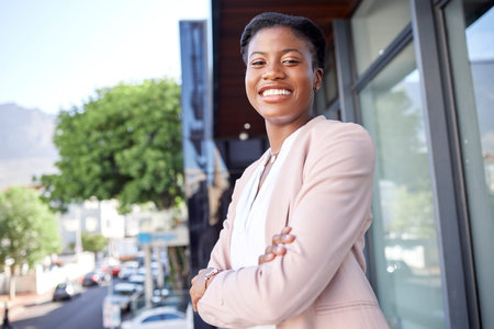 Black woman in city, arms crossed and business employee with smile in portrait outdoor, career...