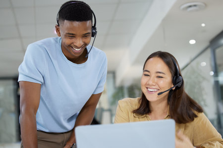 Telemarketing, customer support and manager helping an agent with crm communication in the office. Contact us, headset and call center consultants working on online consultation together in workplaceの写真素材