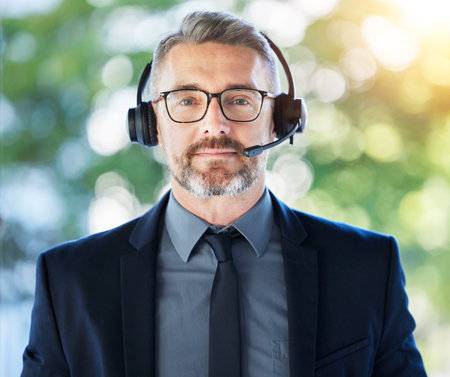 Call center, portrait and senior man with headset, CRM and contact us with communication and professional headshot. Telecom, customer service and male consultant with help desk employee and micの写真素材