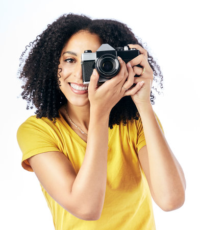 Photography, camera and portrait of woman photographer and happy as a creative isolated in a studio white background. Happy, photoshoot and artistic person with a hobby and takes picture of memoryの写真素材