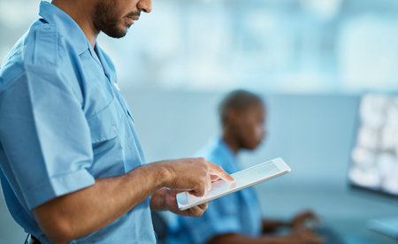 Man, hands and security guard on tablet for surveillance, search or browsing at the office. Male...