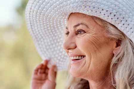 Its the season of smiles. Cropped shot of an attractive senior woman smiling while standing outdoors...