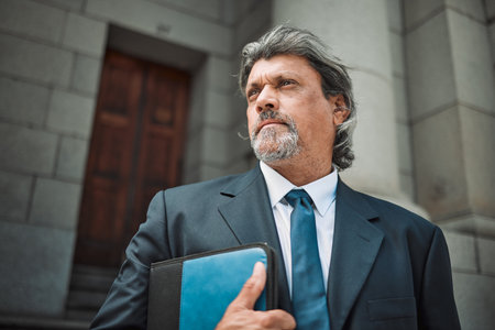 Senior, man or lawyer thinking of justice, education or empowerment working for government by a court. Constitution, mature or proud Indian attorney with knowledge, ideas or vision for legal rightsの写真素材