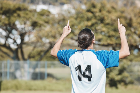 Back, success and a man with a gesture for soccer, game win and celebration of a goal. Happy, field and a football player or athlete excited about a sports achievement, competition or motivationの写真素材