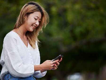 Happy woman, mockup and typing with phone in garden, reading email, social media meme or text....