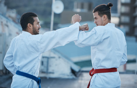 Men, fight and punch in karate class, training and speed with sparring partner, workout and morning for development. Martial arts team, contest and fitness with mma exercise, coaching or sportsの写真素材