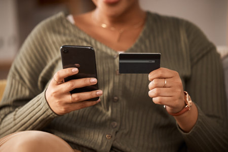 Hands, woman and credit card with phone for online shopping, digital payment and fintech account at...