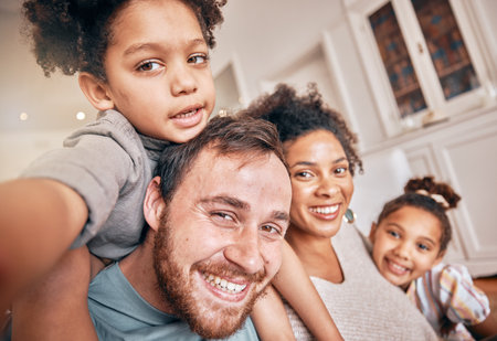 Selfie, smile and piggyback with a blended family in their home together for love, fun or bonding closeup. Portrait, happy or support with parents and kids posing for a playful photograph in a houseの写真素材