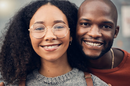 .Face, African couple and love outdoor, happy and bonding together for support in urban city. Portrait, smile and gen z man and woman with profile picture for care, commitment and trust on date.の写真素材