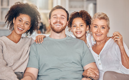 Portrait, family and parents, grandmother and kid in home, bonding and relax together in living room. Face, father and mother, girl and grandma with interracial love, happy or smile for care in houseの写真素材