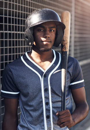 Quitting is not an option. Shot of a young man holding his bat at a baseball game.