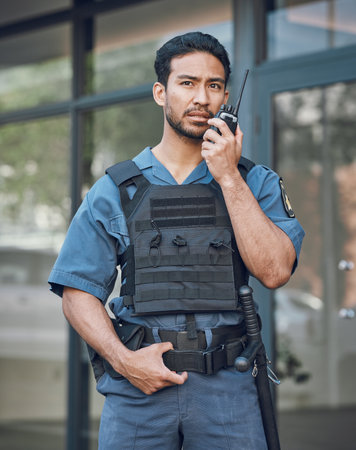 Man, radio and a security guard or bodyguard outdoor on in a city with communication. Safety officer person with a walkie talkie at a building to report crime for investigation and surveillanceの写真素材