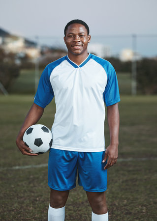 Soccer ball, ready or portrait of black man on field with smile in sports training, game or match on pitch. Happy football player, fitness or proud African athlete in practice, exercise or workoutの写真素材
