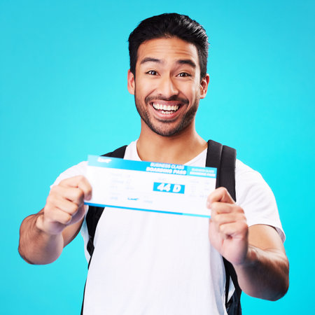 Travel, ticket and portrait of Asian man happy for holiday or vacation flight isolated in a studio...