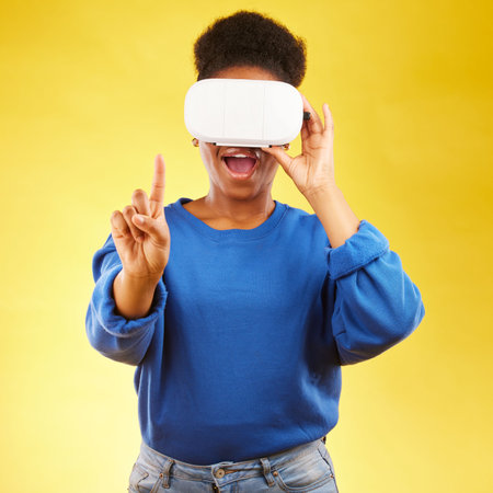 Gaming, metaverse and 3d with black woman and vr in studio for digital, glasses and augmented reality. Technology, future and gamer with female person on yellow background for scifi and gen zの写真素材