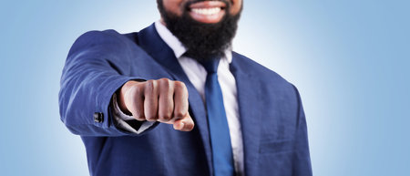Businessman, hands and fist bump for meeting or partnership on banner against a blue studio background. Closeup of man touching for business deal, approval or success in agreement, unity or teamworkの写真素材