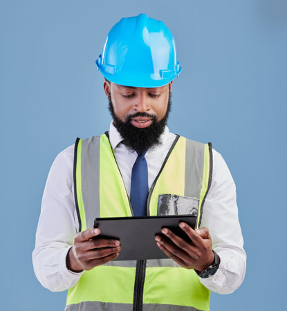 Black man, architect and tablet for construction inspection or planning against a blue studio...