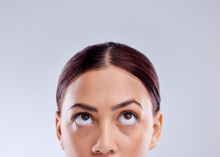 Looking up, mockup or woman thinking of idea in studio isolated on white background to promote beauty. Marketing, natural glowing skincare or face of female model with mock up space for advertisingの写真素材