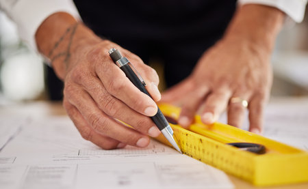 Hands, architecture and ruler for drawing blueprint, paper and engineering of project, building development and illustration. Closeup of man, designer and stationery for lines, sketch and floor planの写真素材